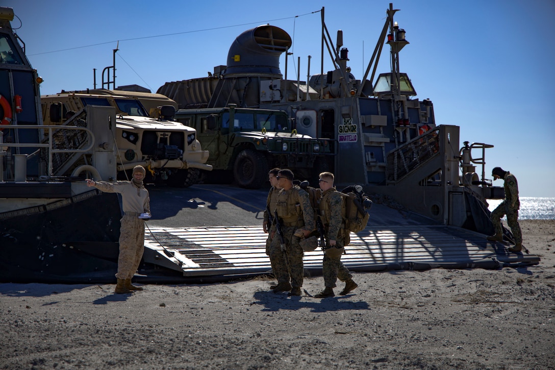 U.S. Marines with the 24th Marine Expeditionary Unit (Special Operations Capable) walk across the beach preparing to head back to base, Onslow Beach, North Carolina, Dec. 2, 2024. The Marines with the 24th MEU (SOC) return to Camp Lejeune following a 7-month long deployment to U.S. Naval Forces Europe and Africa area of operation. Embarked on the Navy’s Wasp Amphibious Ready Group, the 24th MEU (SOC) supported U.S. Allied, and partner interests in the region, including the Eastern Mediterranean Sea, to promote regional stability and deter aggression. (U.S. Marine Corps photo by Sgt. Michele Clarke)