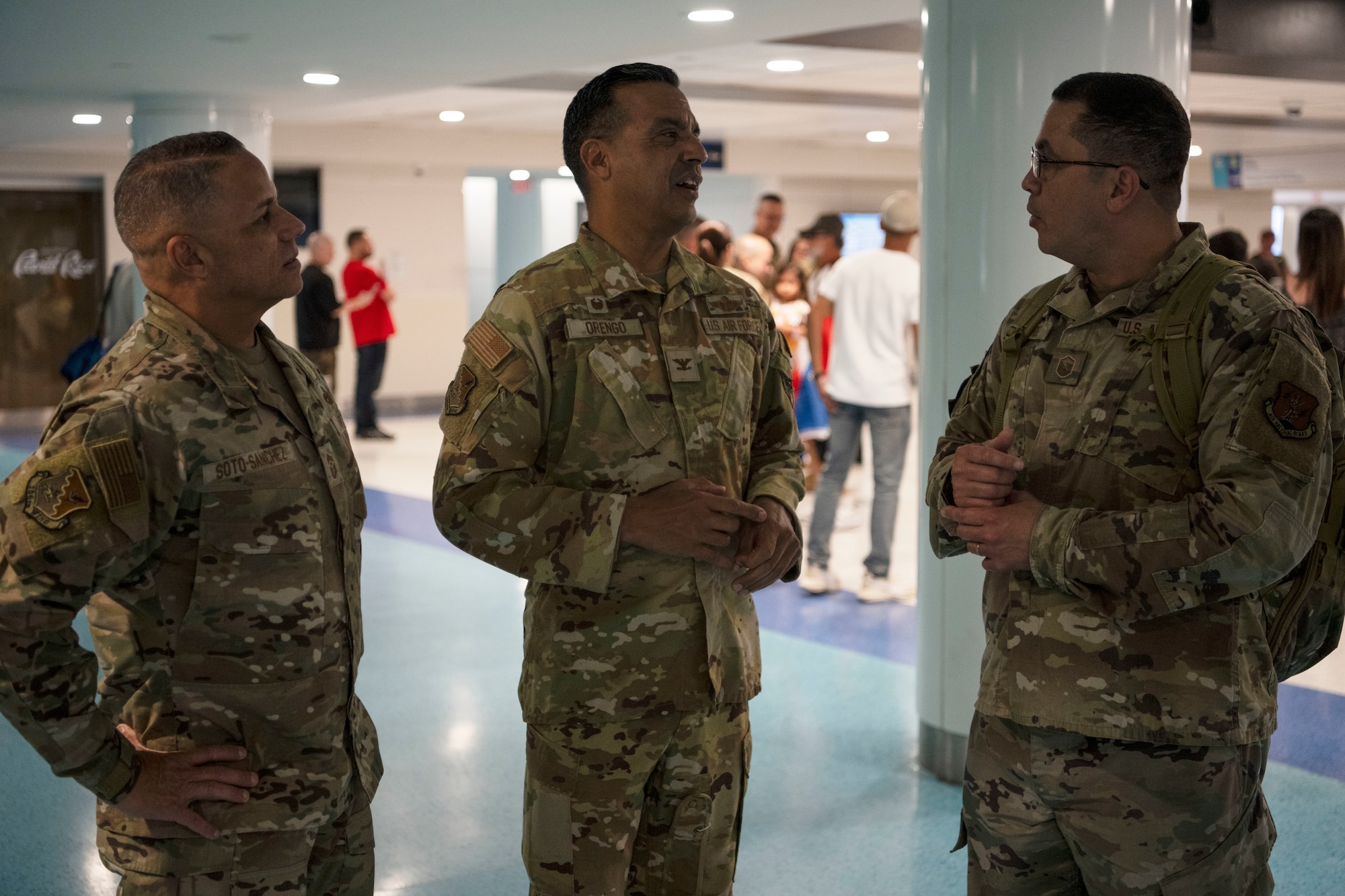U.S. Air Force Col. Evaristo Orengo, commander, 156th Wing and Chief Master Sgt. Orlando Soto, command chief, 156th Wing, greet Master Sgt. Kermit Perez, radar maintainer, 141st Air Control Squadron, all with the Puerto Rico Air National Guard, at the Luis Muñoz Marin International Airport, Carolina, Puerto Rico, April, 18, 2025. Over 50 Airmen with the 141st ACS arrived from a deployment overseas in support of global contingency operations. (U.S. Air National Guard photo by Master Sgt. Rafael Rosa)