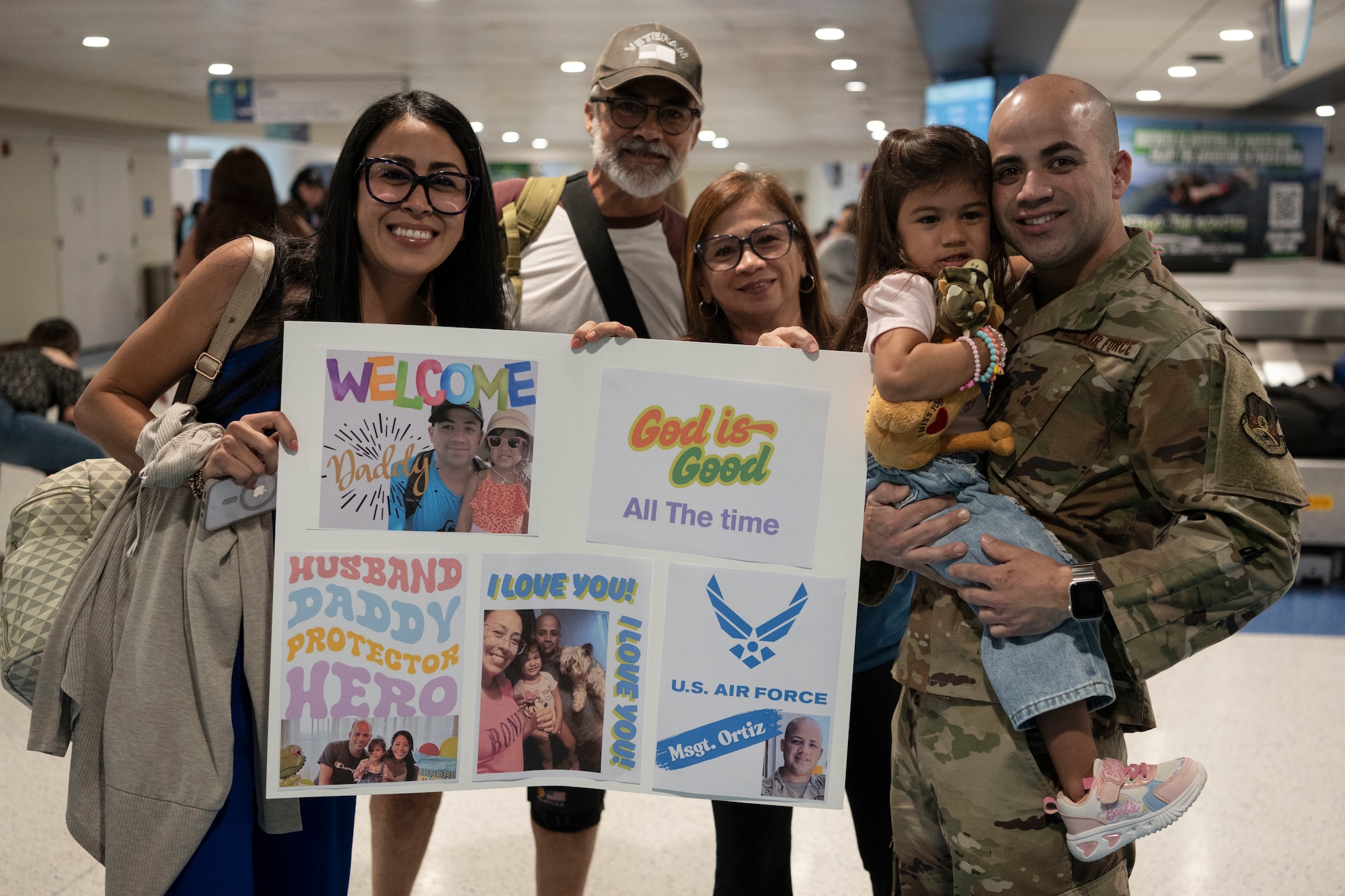 U.S. Air Force Master Sgt. Jonathan Ortiz, power production specialist, 141st Air Control Squadron, Puerto Rico Air National Guard, poses for a group photo with his family at the Luis Muñoz Marin International Airport, Carolina, Puerto Rico, April, 18, 2025. Over 50 Airmen with the 141st ACS arrived from a deployment overseas in support of global contingency operations. (U.S. Air National Guard photo by Master Sgt. Rafael Rosa)