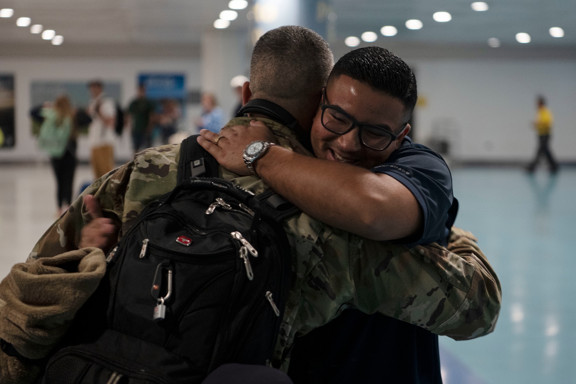 U.S. Air Force Master Sgt. William Rosario, radar specialist, 141st Air Control Squadron, Puerto Rico Air National Guard, greets friends at the Luis Muñoz Marin International Airport, Carolina, Puerto Rico, April, 18, 2025. Over 50 Airmen with the 141st ACS arrived from a deployment overseas in support of global contingency operations. (U.S. Air National Guard photo by Master Sgt. Rafael Rosa)