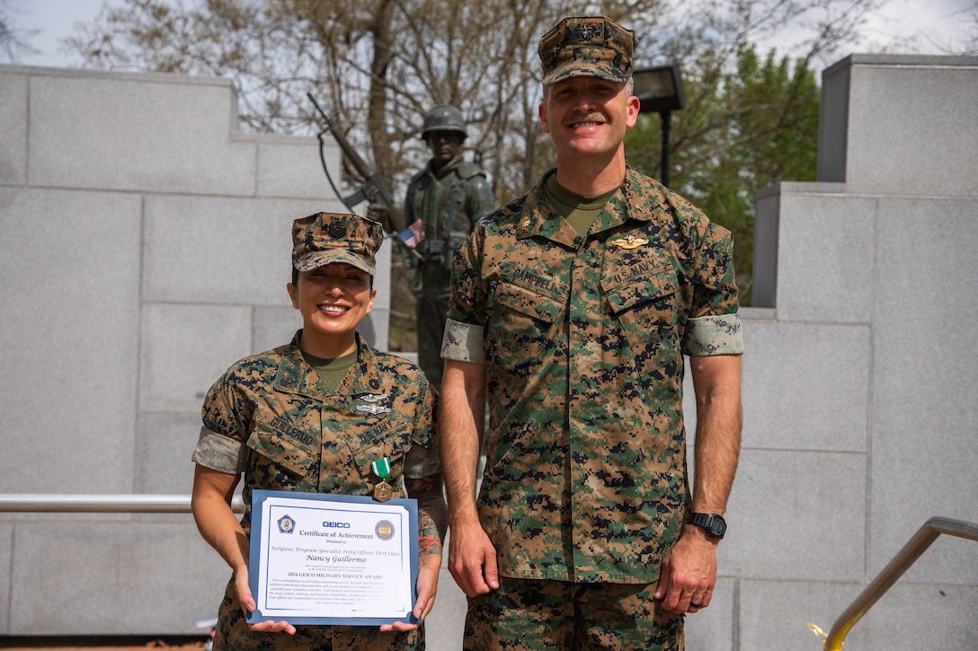 U.S Navy Petty Officer First Class Nancy Guillermo, a Queens, New York native with the 24th Marine Expeditionary Unit (MEU), poses for a portrait with U.S. Navy Chaplain Lieutenant Commander Jim Campbell (right) after being awarded a Navy Commendation Medal and the 2024 GEICO Military Service Award at the Lejeune Memorial Gardens, Jacksonville, N.C., March 24, 2025. As the 24th MEU’s Religious Programs Specialist, Guillermo organized and participated in multiple volunteer opportunities and community relation events during the pre-deployment training cycle and deployment. (U.S. Marine Corps photo by Cpl. Victoria Hutt)