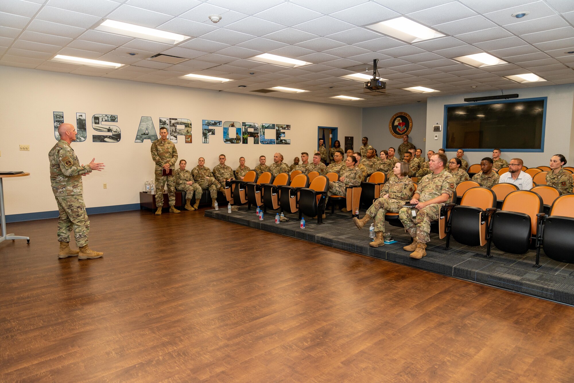 Airmen sitting in a theatre.
