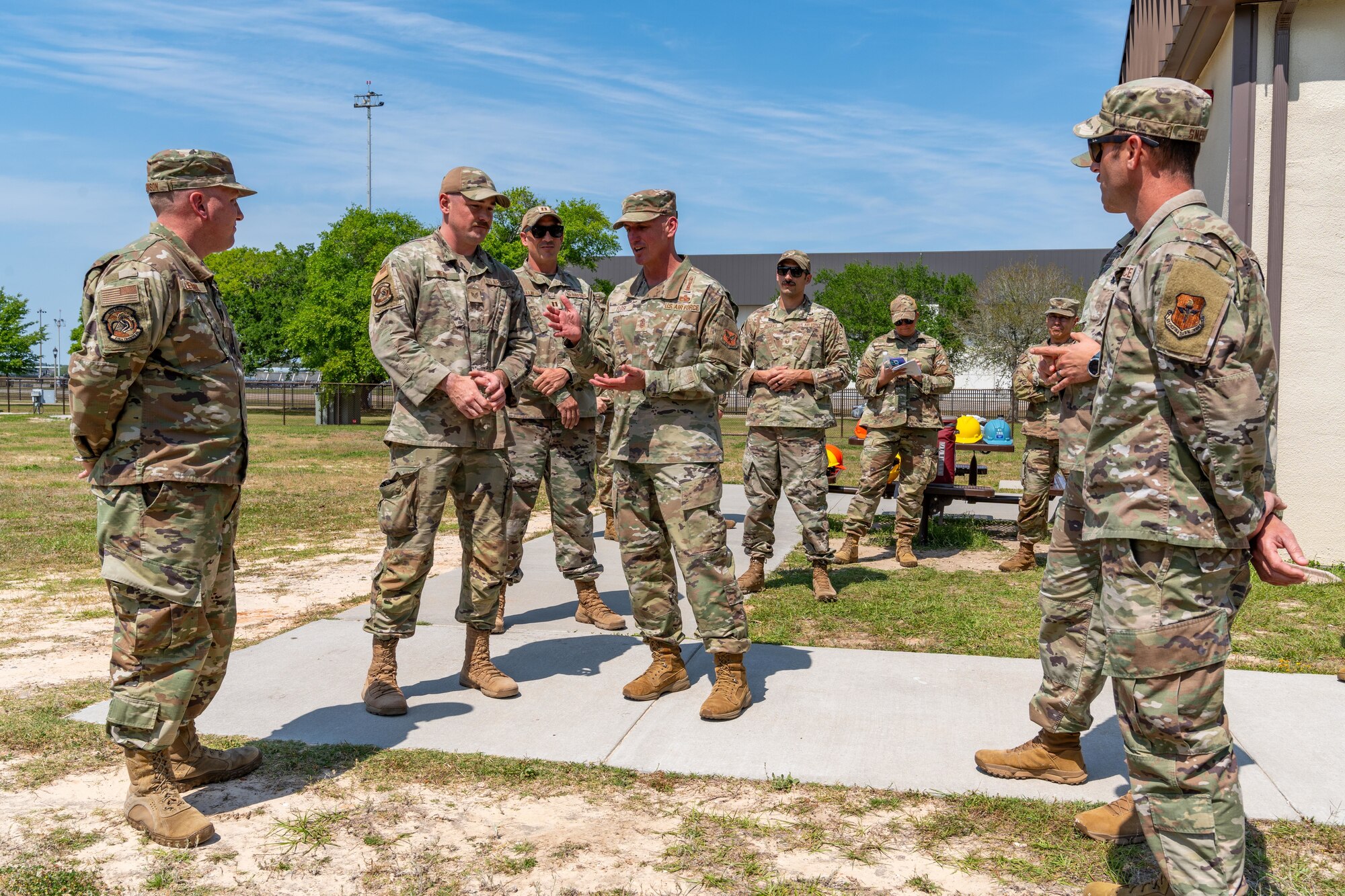 Airmen conversing outside.