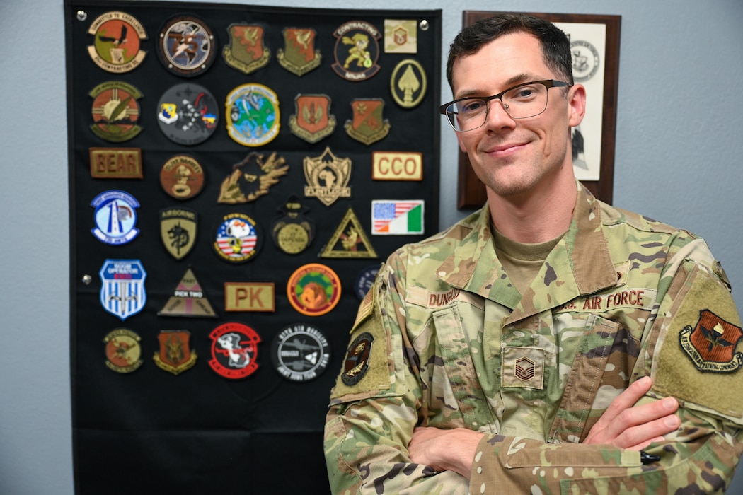 U.S. Air Force Master Sgt. Joshua D. Dunrud, 97th Contracting Squadron senior enlisted leader, stands by his collection of military patches at Altus Air Force Base, Oklahoma, April 23, 2025. Dunrud was recently accepted to the Naval Postgraduate School located in Monterey, California.