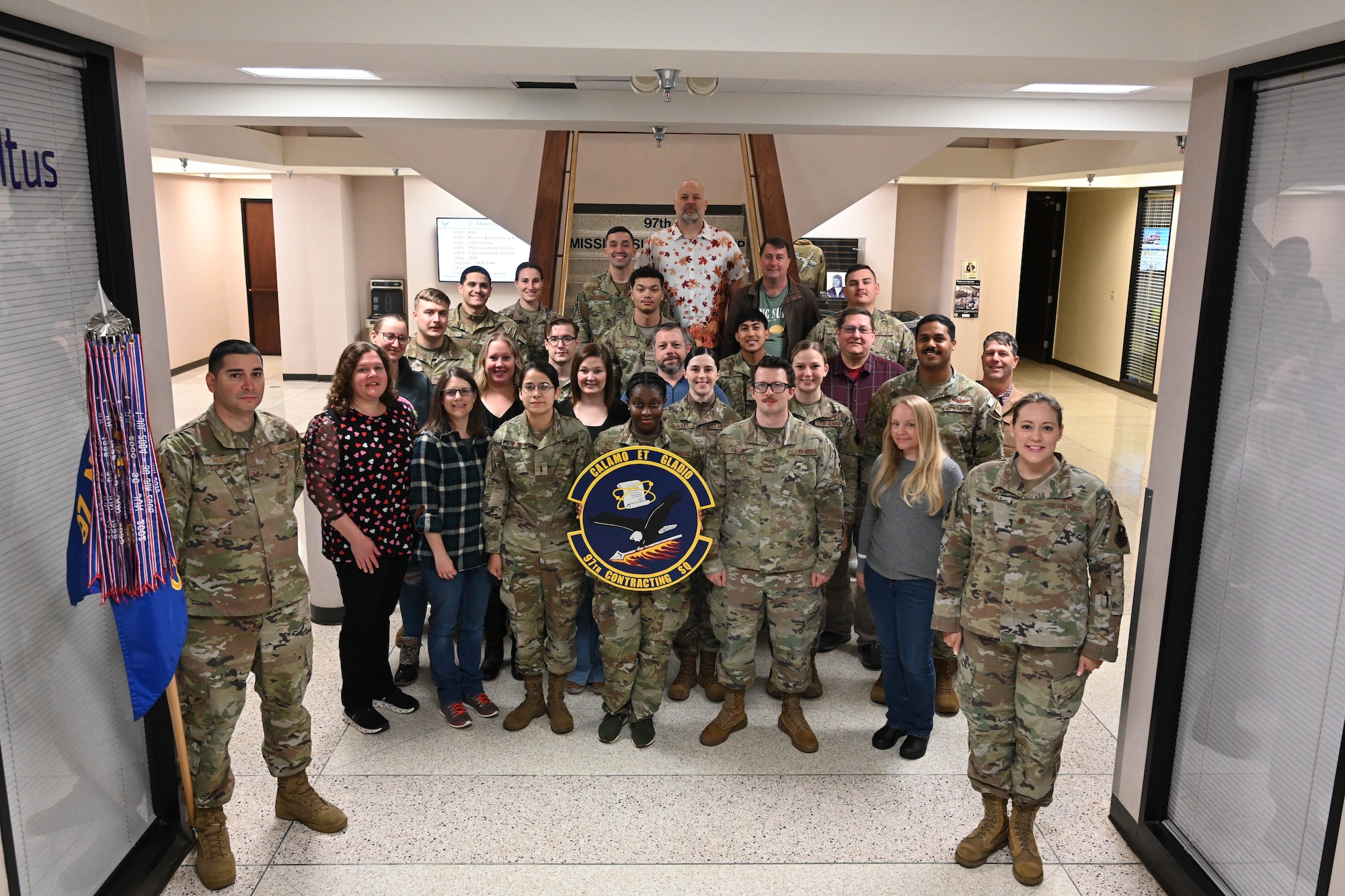 The 97th Contracting Squadron (CONS) poses for a photo at Altus Air Force Base, Oklahoma, November 8, 2024. The 97th CONS is made up of the Base Support, Infastructure, and Construction flights. (U.S. Air Force Photo by Senior Airman Miyah Gray)