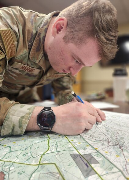 U.S. Air Force Airman 1st Class Elijah Harris, 104th Fighter Wing (FW) public affairs specialist, reads a map prior to leaving for the Massachusetts National Guard 2025 Best Warrior Competition, 104th Fighter Wing, Westfield Ma April 9, 2025. Harris represented the 104th FW while competing against members of the Air and Army National Guard, Kenya Defense Forces and Irish Defense Forces. (U.S. Air National Guard Photo by Jerry Hewitt)