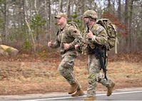 U.S. Air Force Airman 1st Class Elijah Harris, 104th Fighter Wing (FW) public affairs specialist, and Tech. Sgt Shane Coakley, 104th Security Forces, run during the Massachusetts National Guard 2025 Best Warrior Competition, Camp Edwards, Massachusetts, April 11, 2025. Harris represented the 104th FW while competing against members of the Air and Army National Guard, Kenya Defense Forces and Irish Defense Forces. (U.S. Air National Guard Photo by Melanie J. Casineau)