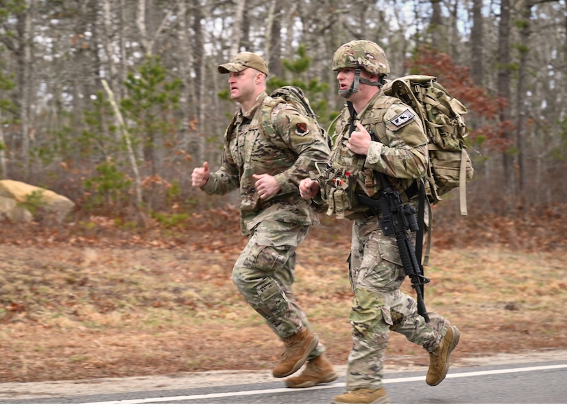 U.S. Air Force Airman 1st Class Elijah Harris, 104th Fighter Wing (FW) public affairs specialist, and Tech. Sgt Shane Coakley, 104th Security Forces, run during the Massachusetts National Guard 2025 Best Warrior Competition, Camp Edwards, Massachusetts, April 11, 2025. Harris represented the 104th FW while competing against members of the Air and Army National Guard, Kenya Defense Forces and Irish Defense Forces. (U.S. Air National Guard Photo by Melanie J. Casineau)