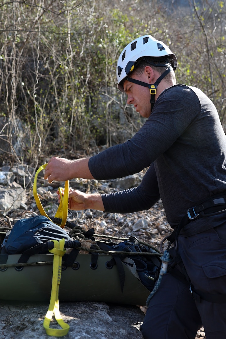 U.S. Navy Hospital Corpsman 2nd Class Connor Dougherty, a medic with Defense POW/MIA Accounting Agency, prepares a Skedco stretcher for a medical evacuation rehearsal during a recovery mission in Laos, Mar. 2, 2025.