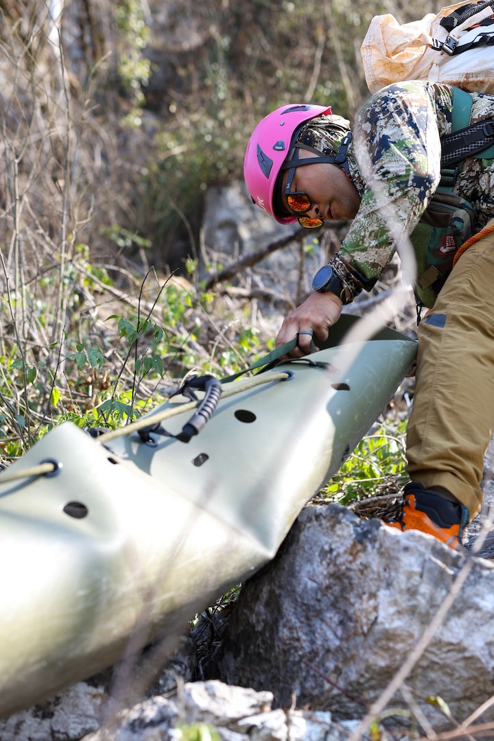 U.S. Air Force Tech Sgt. Joshua Pyo, a mountaineer with Defense POW/MIA Accounting Agency lowers a Skedco stretcher for a medical evacuation rehearsal during a recovery mission in Laos, Mar. 2, 2025.