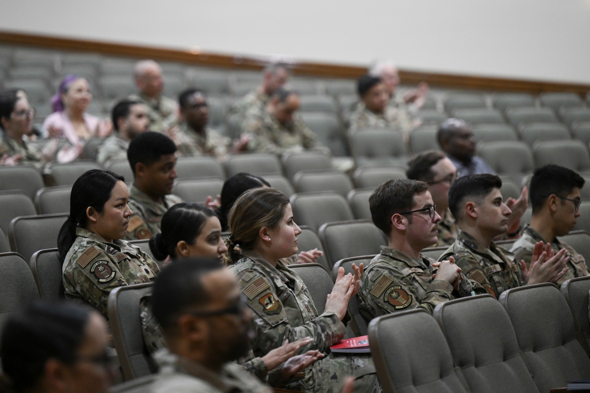 U.S. Airmen and attendees from the local community applaud during the Understanding China’s Aerospace event at Joint Base Andrews, Md., April 21, 2025. The event featured a presentation by Dr. Brendan Mulvaney, director of the Department of the Air Force China Aerospace Studies Institute. (U.S. Air Force photo by Senior Airman Gianluca Ciccopiedi)