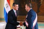 President Santiago Peña, the President of the Republic of Paraguay, left, presents the Order of Merit 
