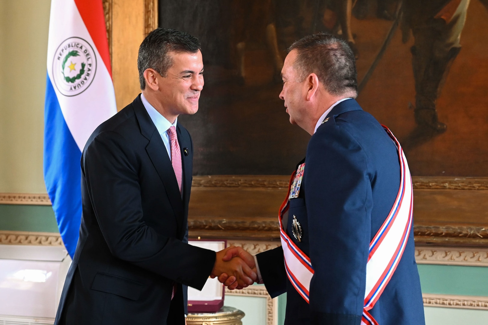 President Santiago Peña, the President of the Republic of Paraguay, left, presents the Order of Merit "Gral Div Bernardino Caballero" in the grade of “Gran Cross” to  U.S. Air Force Maj. Gen. Gary Keefe, The Adjutant General, Massachusetts National Guard, in the Independence Hall of the Government Palace, Asunción, Paraguay, April 24, 2025.