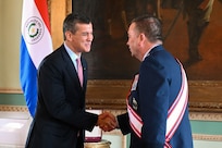 President Santiago Peña, the President of the Republic of Paraguay, left, presents the Order of Merit "Gral Div Bernardino Caballero" in the grade of “Gran Cross” to  U.S. Air Force Maj. Gen. Gary Keefe, The Adjutant General, Massachusetts National Guard, in the Independence Hall of the Government Palace, Asunción, Paraguay, April 24, 2025.
