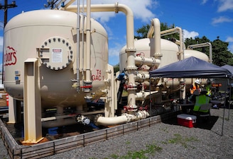 HONOLULU (April. 14, 2025) Contractors with Navy Closure Task Force-Red Hill (NCTF-RH) collect water samples from granular activated carbon filtration tanks connected to the Navy Aiea Halawa Shaft (NAHS) in Honolulu, April 14, 2025. The water samples were taken as part of a pilot study in preparation for the reactivation of the NAHS.  Charged with the safe decommissioning of the Red Hill Bulk Fuel Storage Facility, NCTF-RH was established by the Department of the Navy as a commitment to the community and the environment. NCTF-RH continues to engage with the people of Hawaii, regulatory agencies, and other stakeholders as it safely and deliberately decommissions the facility. (U.S. Navy photo by Mass Communication Specialist 1st Class Glenn Slaughter)