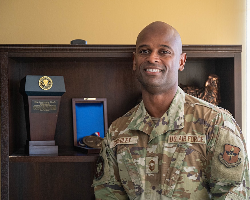 U.S. Air Force Chief Master Sgt. Leray Smedley, 13th Combat Air Base Squadron senior enlisted leader, poses for a photo in his office, Mar. 31, 2025, at Luke Air Force Base, Arizona.
