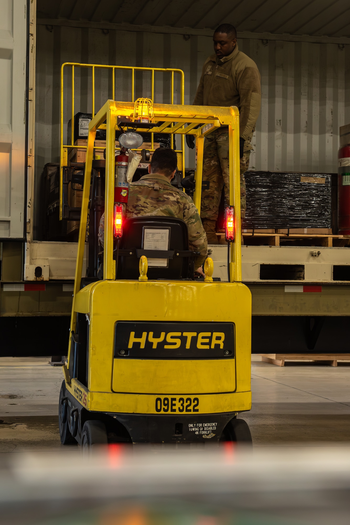 U.S. Air Force Senior Airman Steven Barboza, left, and U.S. Air Force Airman 1st Class Andrew Davis, 35th Logistic Readiness Squadron (LRS) ground transport operators, load cargo for the Rhino Express program.