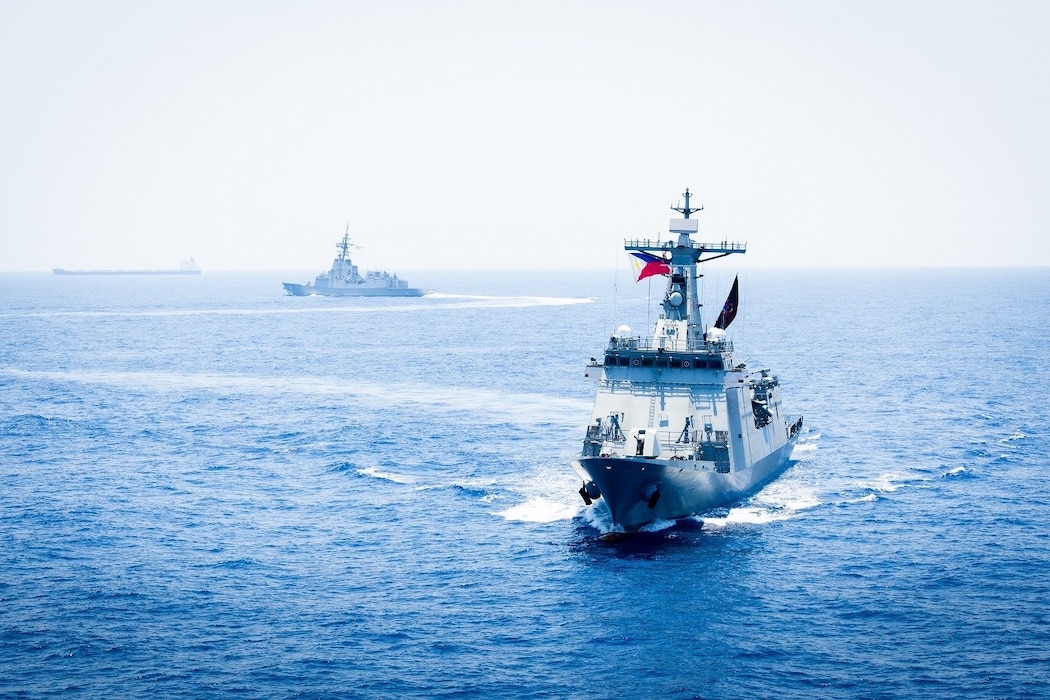 U.S. Marine Corps and U.S. Air Force aircraft, off frame, integrate with the Philippine Navy Jose Rizal-class guided-missile destroyer BRP Antonio Luna (FF151), right, and the Royal Australian Navy Hobart-class guided-missile destroyer HMAS Sydney (DDG 42), center, to conduct a multilateral Maritime Cooperative Activity within the Philippines’ Exclusive Economic Zone, April 29, 2025.