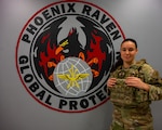 Senior Airman Alexa Reeves, 105th Security Support Squadron Phoenix Raven, poses for a photo in front of a Raven painting, at Stewart Air National Guard Base, New York, Mar. 3, 2025. As a Raven, Reeves provides protection for the 105th Airlift Wing’s C-17 Globemaster III aircraft and crews transiting through austere locations where security is unknown or additional security is needed to counter higher threat levels. (U.S. Air National Guard photo by Senior Airman Sarah Post)