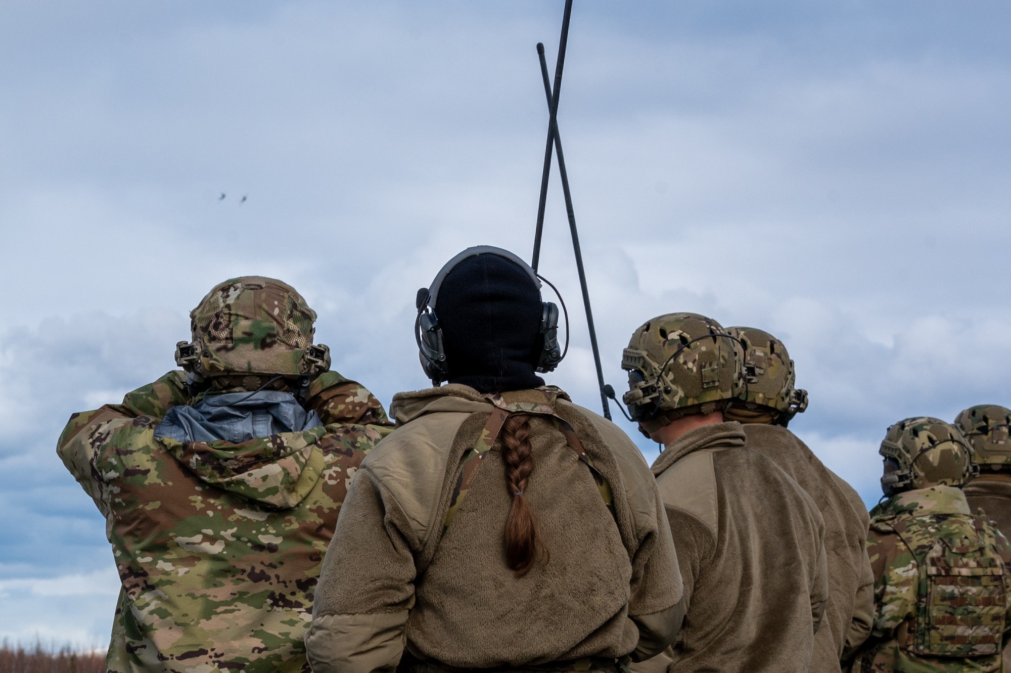 U.S. Air Force Airmen assigned to 3rd Operations Support Squadron conduct Landing Zone Safety Officer training at Malamute Drop Zone with F-22 Raptors assigned to 90th Fighter Squadron on Joint Base Elmendorf-Richardson, Alaska, April 21, 2025.