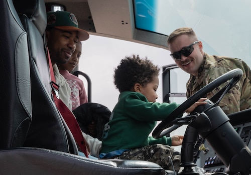 children of airmen siting in a fire truck