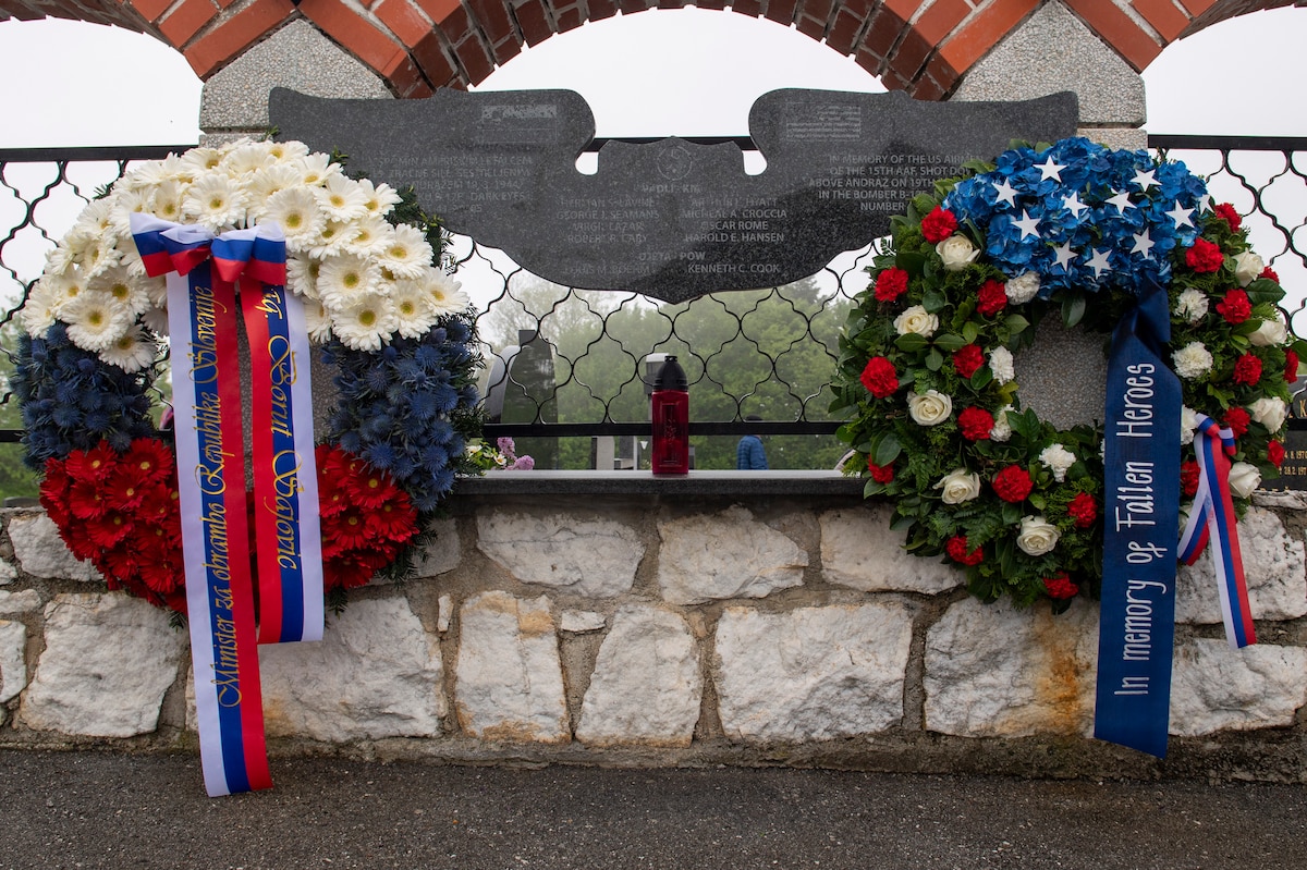 Two wreathes set below a plaque