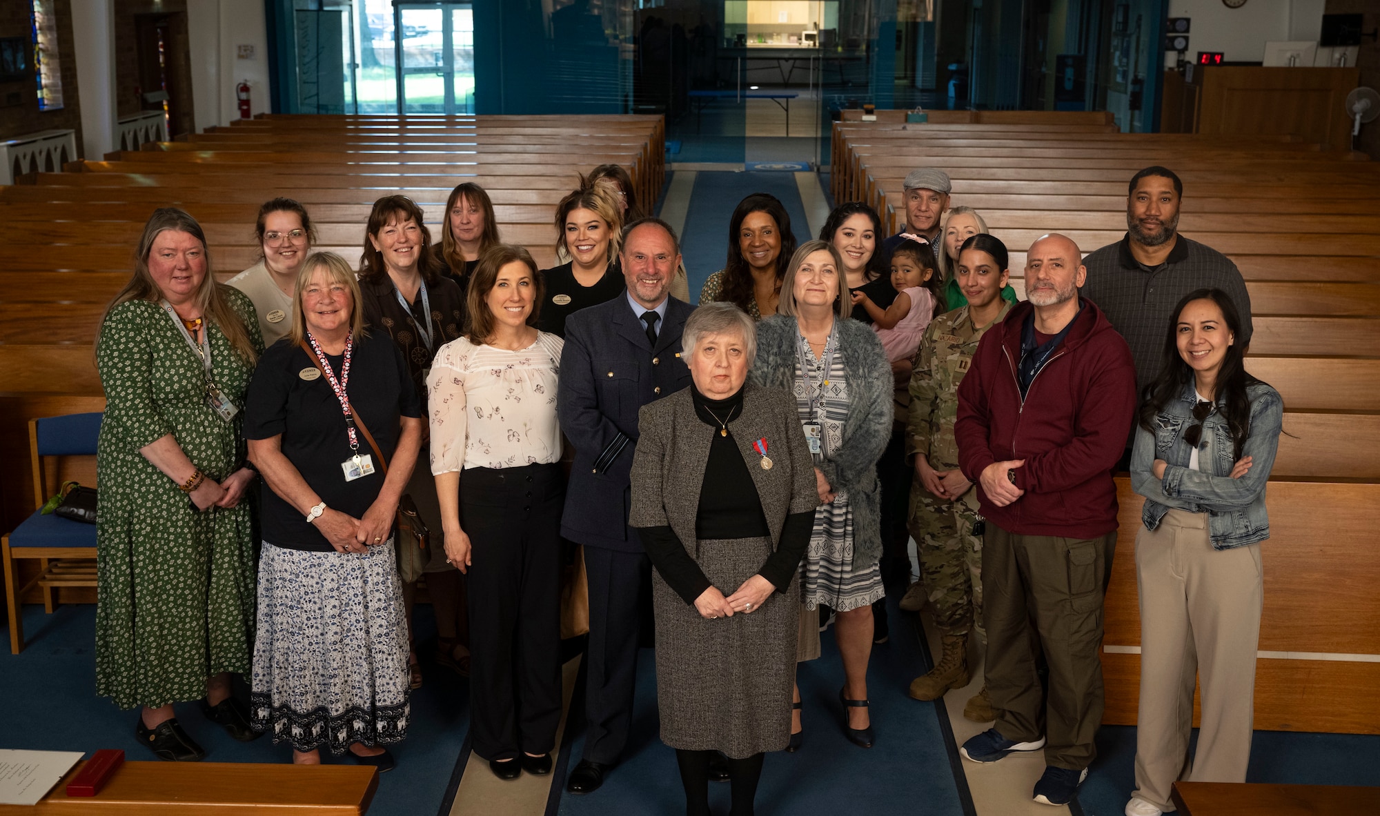 Nancy Tarling-Parker, center, retired Ministry of Defence civil servant, poses with friends and co-workers during her Imperial Service Medal ceremony at RAF Mildenhall, England, April 29, 2025.