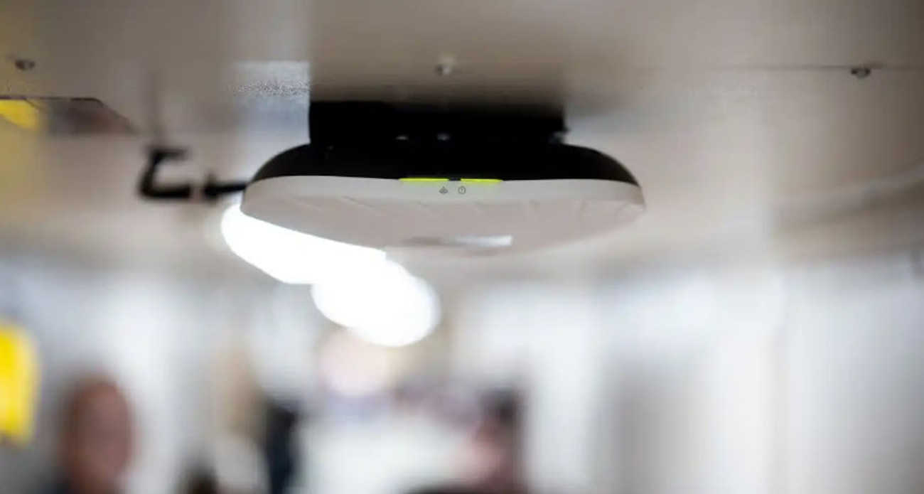 Photo of a Starshield wireless access point mounted on the ceiling of a ship.