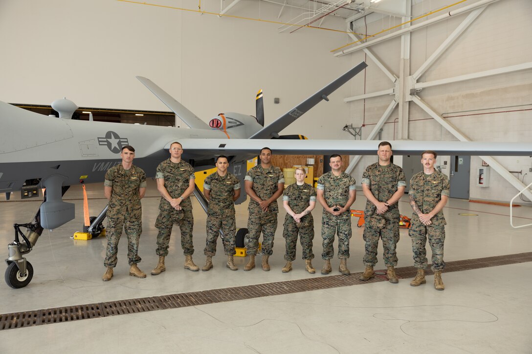 U.S. Marines with Marine Unmanned Aerial Vehicle Training Squadron (VMUT) 2 pose for a picture in front of an MQ-9A Reaper on the first day of the Marine Initial Qualification Training (IQT) course at Marine Corps Air Station Cherry Point, North Carolina, April 28, 2025. VMUT-2 began its first Marine IQT course as a fleet replacement squadron, the Marine Corps' only Group 5, MQ-9A Reaper, graduate-level course for MQ-9 pilots and sensor operators. (U.S. Marine Corps photo by Pfc. Gavin K. Kulczewski)