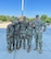 Five Soldiers in duty uniform pose for a photo outside.