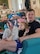 Man and young daughter sit in a sofa chair in their house.