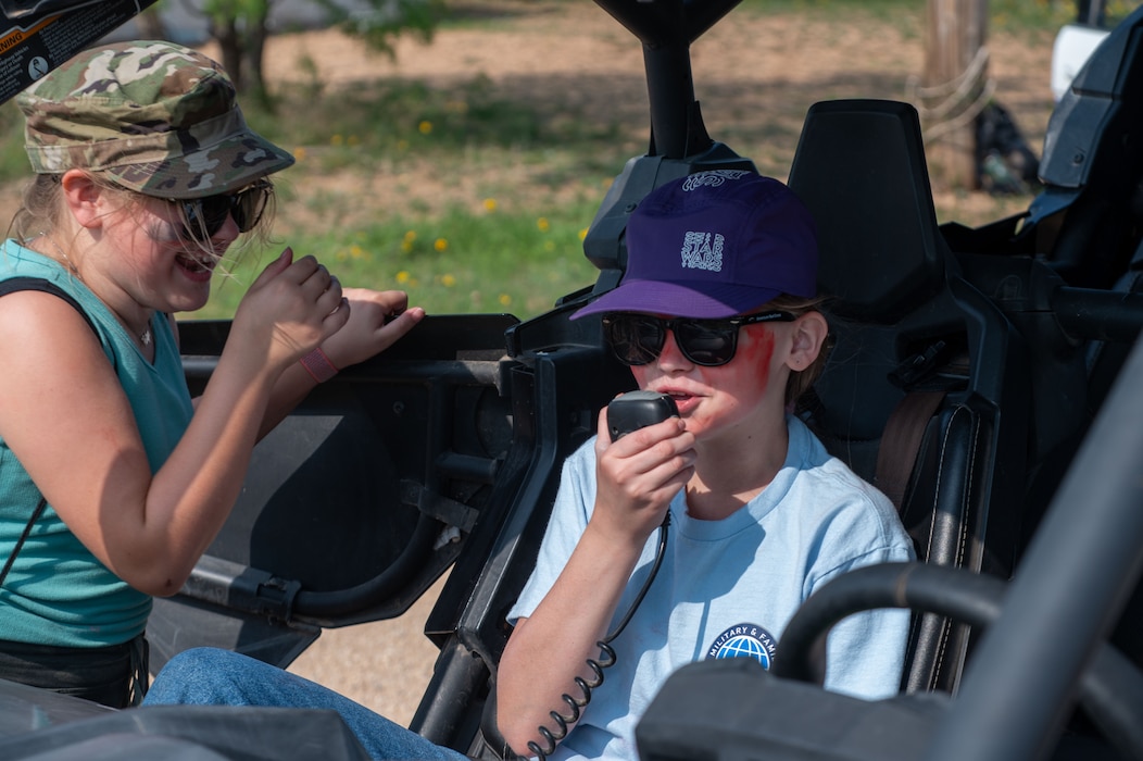 Operation KIDS participants use a radio while sitting in a 17th Security Forces Squadron all-terrain vehicle at Goodfellow Air Force Base, Texas, April 26, 2025. The annual event gives local and military children a hands-on look at the deployment process, including interactive demonstrations from various base units.  (U.S. Air Force photo by Airman 1st Class James Salellas)