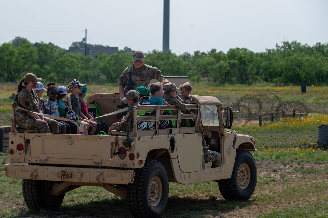 Participants of the 2025 Operation KIDS event ride in a Humvee at Goodfellow Air Force Base, Texas, April 26, 2025.  More than just an educational experience, Operation Kids highlighted the value of empathy, communication, and resilience within military households.  (U.S. Air Force photo by Airman 1st Class James Salellas)