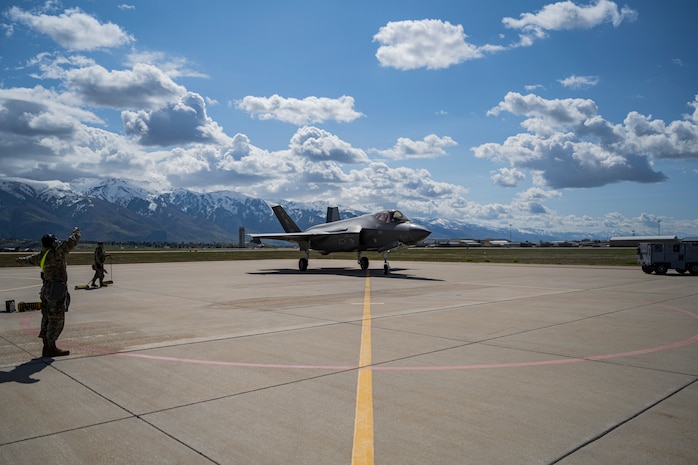 A photo of Airmen marshaling an F-35 on the flight line at Hill Air Force Base, Utah