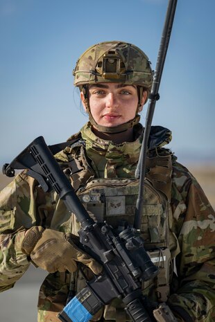 A portrait of of an Airman in battle gear looking into the camera