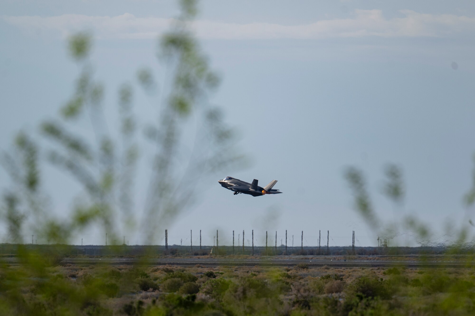 A photo of an F-35 taking off from a desert runway