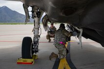 A photo of Airmen loading missiles into and F-35
