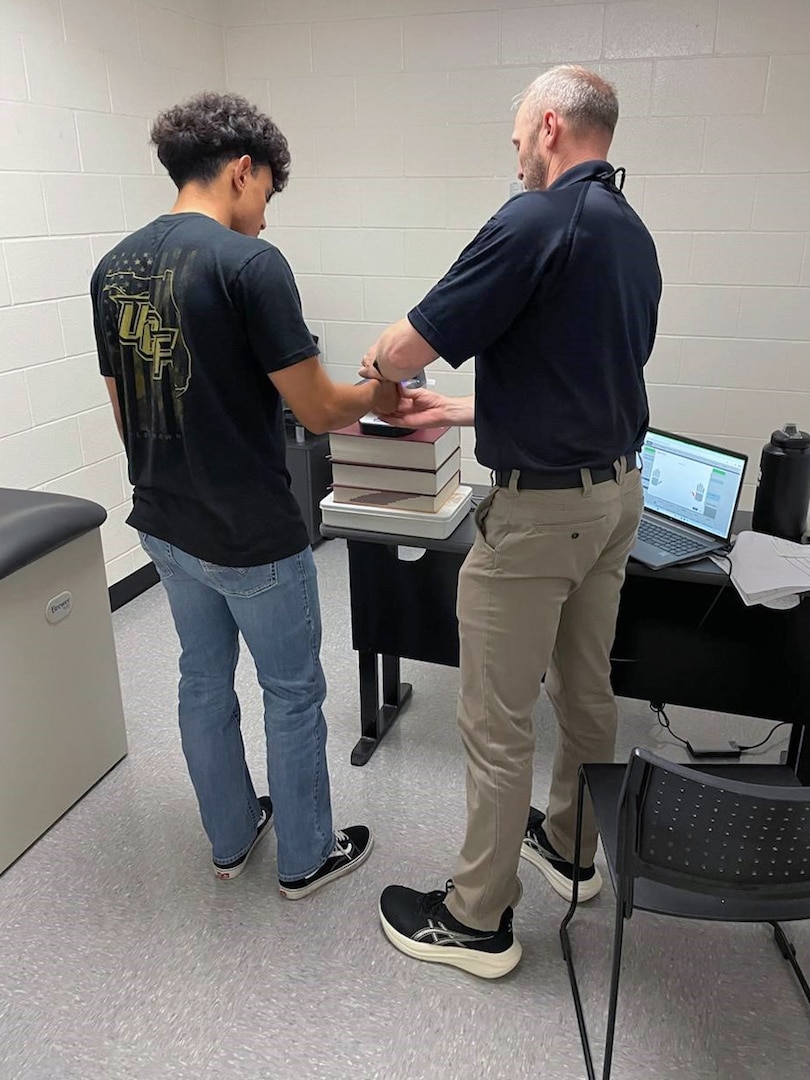 (R) Steven Connor, Houston MEPS human resources assistant, captures applicant fingerprints at the first ever "MEPS in a Box." USMEPCOM launched the mobile "MEPS in a Box" initiative with a pilot in Austin, Texas, April 28-30, to provide full-service applicant processing in underserved areas and expand recruiting capacity.