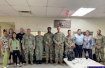 USMEPCOM personnel pose for a photo during stand up of the first ever 