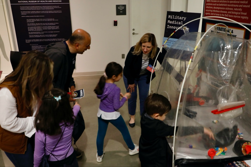 SILVER SPRING, Md. (25 April, 2025) Dr. Jill Phan, Naval Medical Research Command (NMRC) science director, explains technology used by the command to conduct research on behalf of service members to visitors at the National Museum of Health and Science’s Military Medical Innovation event. NMRC, headquarters of Navy Medicine Research & Development, is engaged in a broad spectrum of activity from basic science in the laboratory to field studies in austere and remote areas of the world to investigations in operational environments. In support of Navy, Marine Corps and joint U.S. warfighter health, readiness and lethality, researchers study infectious diseases, biological warfare detection and defense, combat casualty care, environmental health concerns, aerospace and undersea medicine, operational mission support and epidemiology. For 250 years, Navy Medicine, represented by more than 44,000 highly-trained military and civilian healthcare professionals, has delivered quality healthcare and enduring expeditionary medical support to the warfighter on, below, and above the sea and ashore. (U.S. Navy photo by Sidney Hinds /Released)