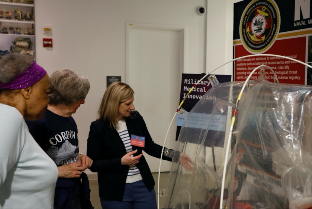 SILVER SPRING, Md. (25 April, 2025) Dr. Jill Phan, Naval Medical Research Command (NMRC) science director, explains technology used by the command to conduct research on behalf of service members to visitors at the National Museum of Health and Science’s Military Medical Innovation event. NMRC, headquarters of Navy Medicine Research & Development, is engaged in a broad spectrum of activity from basic science in the laboratory to field studies in austere and remote areas of the world to investigations in operational environments. In support of Navy, Marine Corps and joint U.S. warfighter health, readiness and lethality, researchers study infectious diseases, biological warfare detection and defense, combat casualty care, environmental health concerns, aerospace and undersea medicine, operational mission support and epidemiology. For 250 years, Navy Medicine, represented by more than 44,000 highly-trained military and civilian healthcare professionals, has delivered quality healthcare and enduring expeditionary medical support to the warfighter on, below, and above the sea and ashore. (U.S. Navy photo by Sidney Hinds /Released)