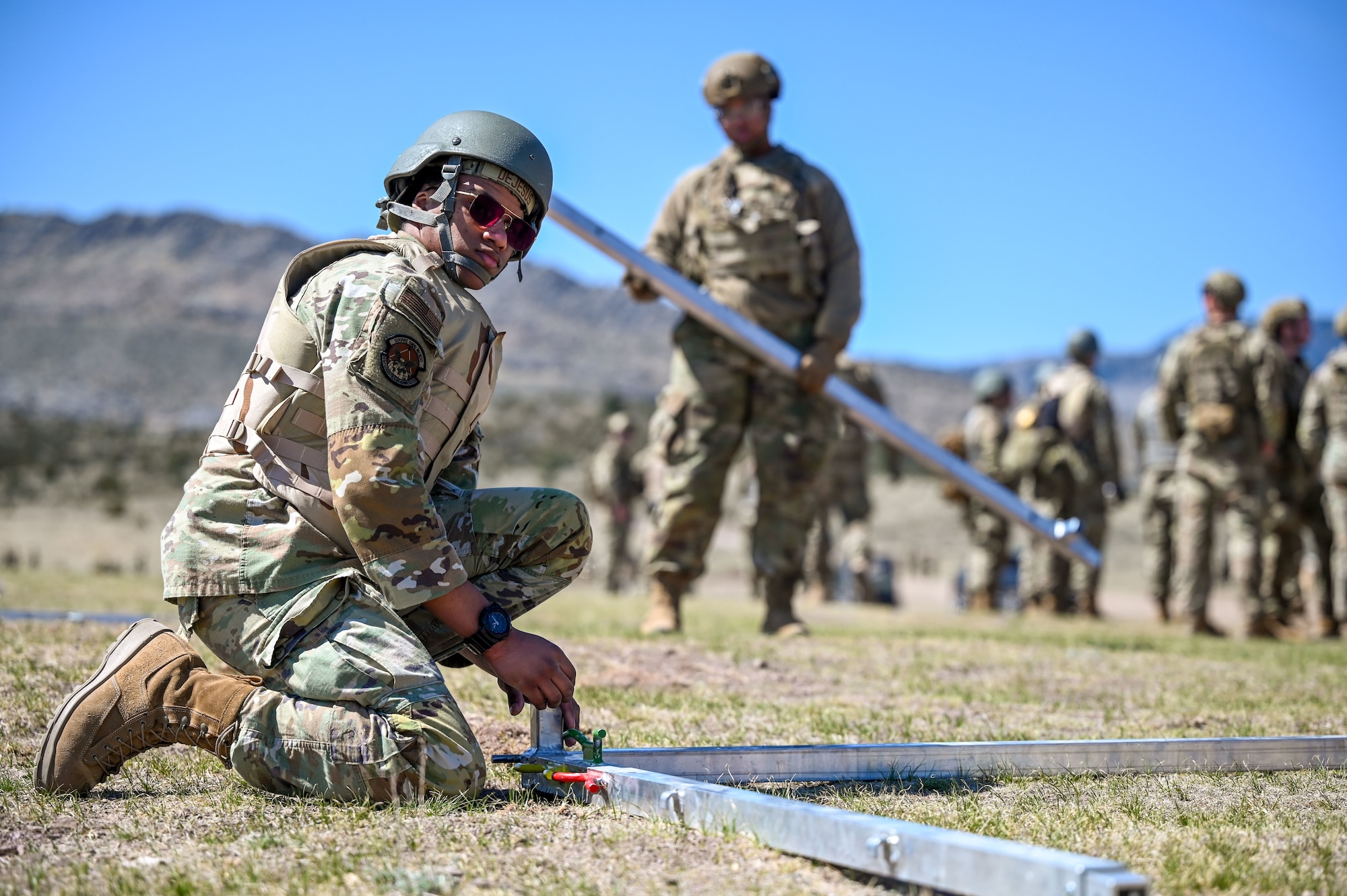 An Airman putting two metal pieces together.