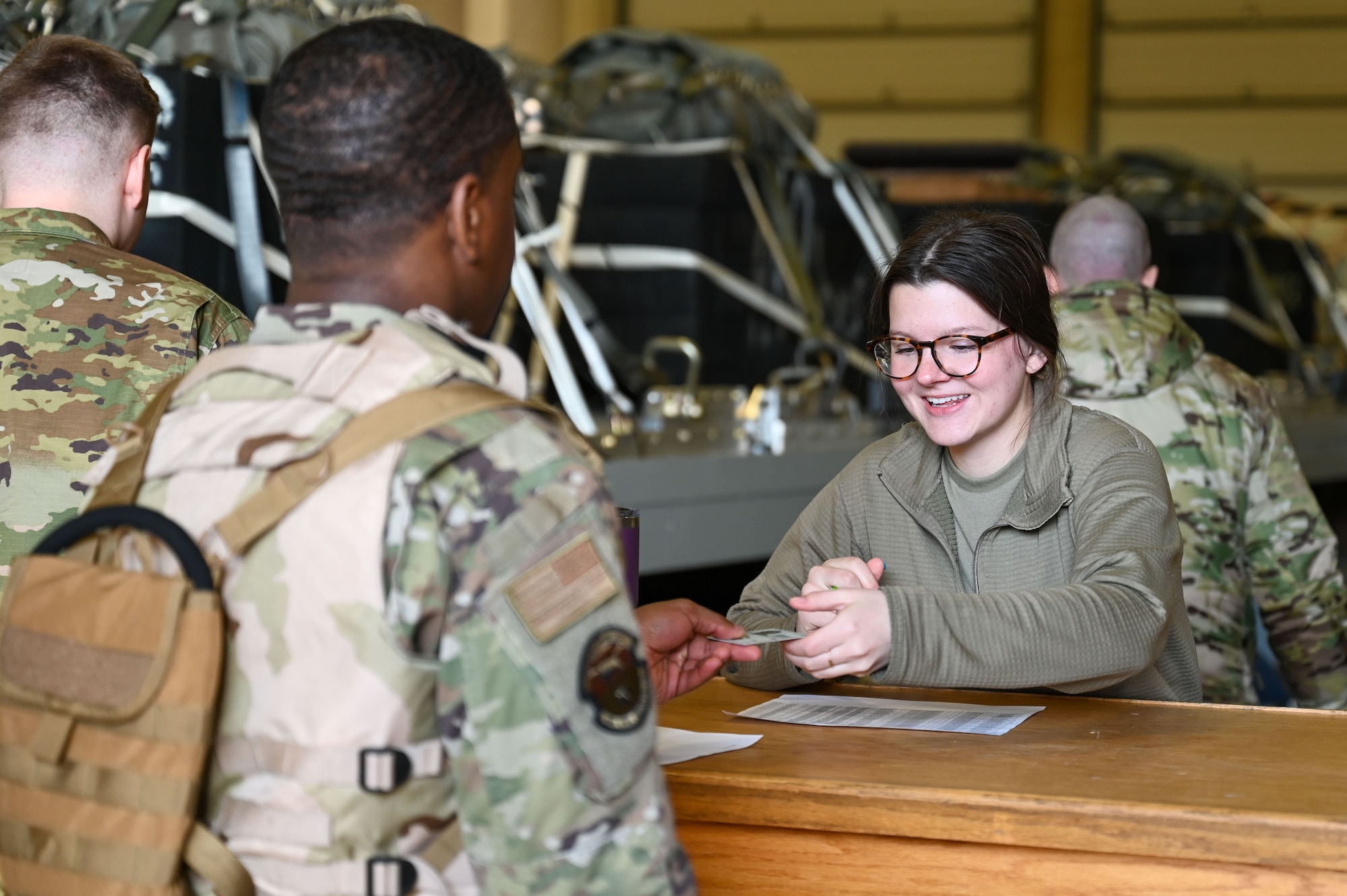 Airman handing identification to another Airman.