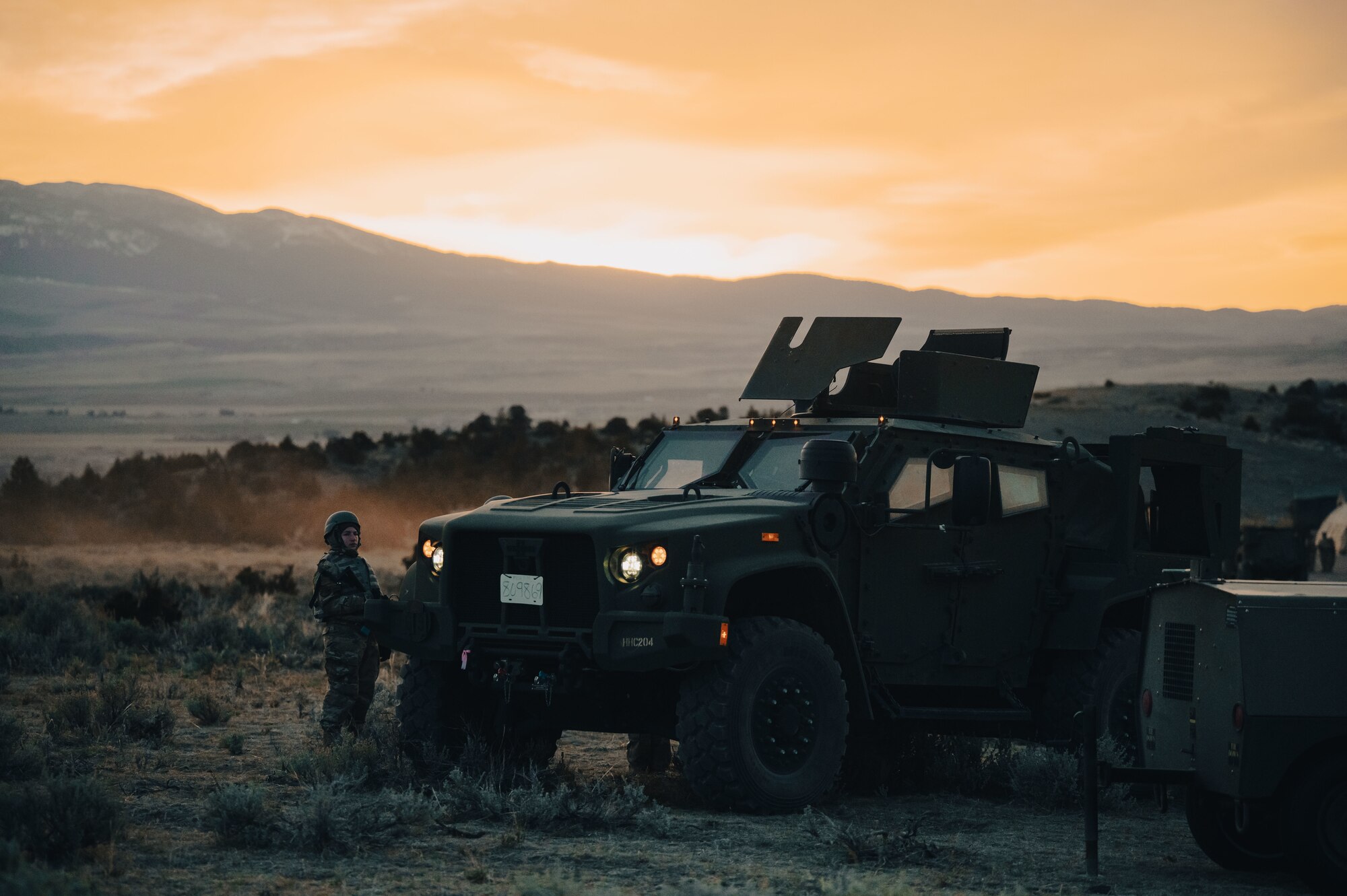 joint light tactical vehicle with Airman standing next to it.