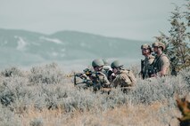 Four Airmen, two with their weapons drawn.