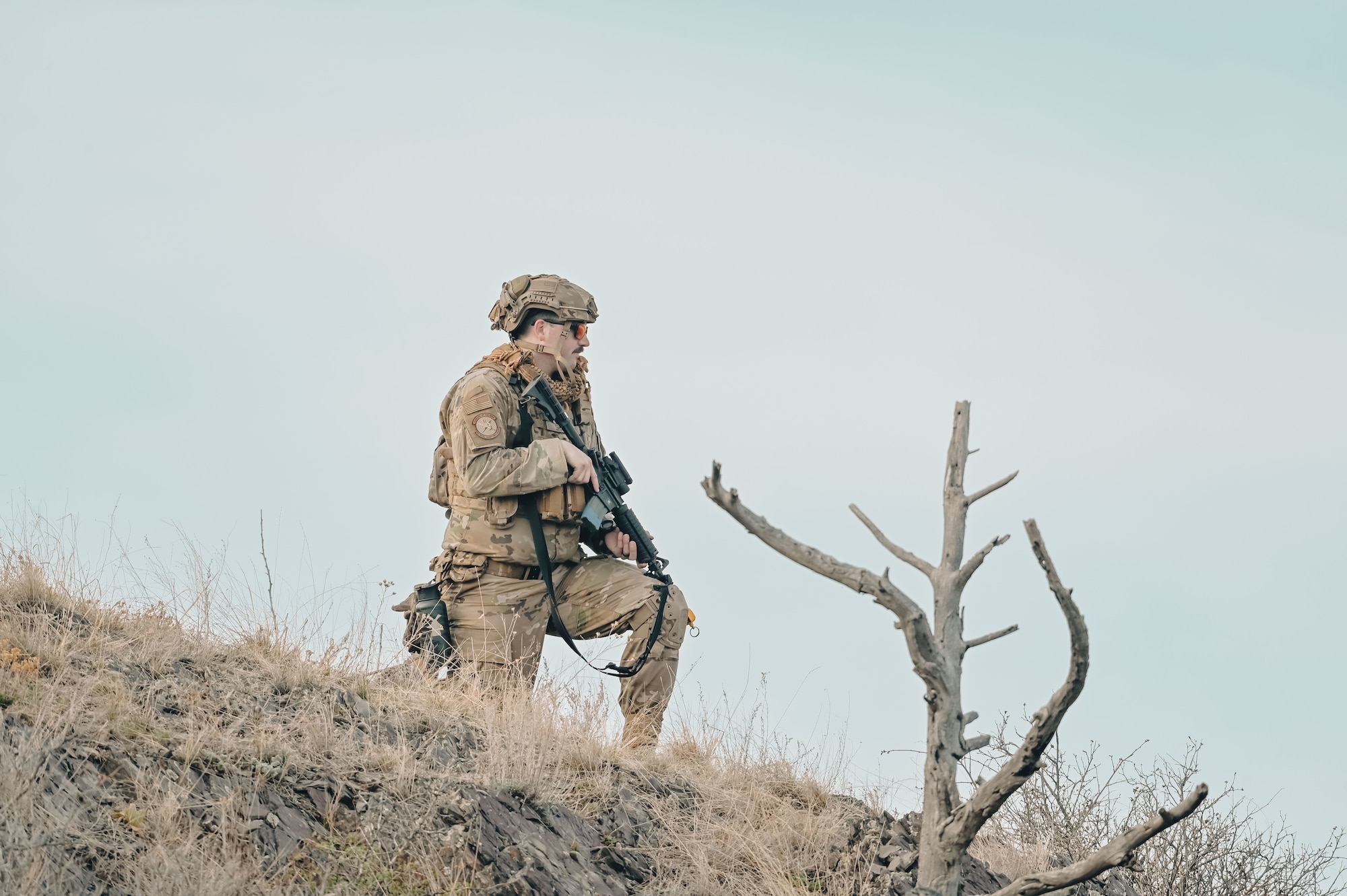 Airman looking off into the distance on a hill