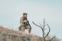 Airman looking off into the distance on a hill