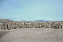 Airmen group photo with mountains in background.