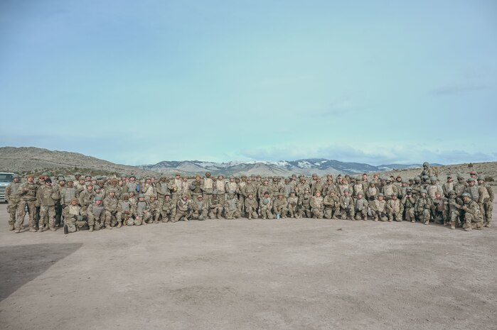 Airmen group photo with mountains in background.