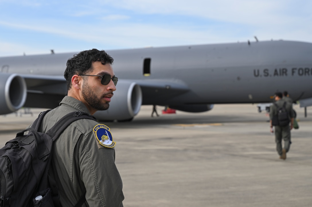 U.S. Air Force Senior Airman Ata Chaudhry, a boom operator assigned to the 756th Air Refueling Squadron, walks toward a KC-135 Stratotanker at Joint Base Andrews, Md., April 22, 2025. Chaudhry participated in an aerial refueling mission supporting the 4th Fighter Wing. (U.S. Air Force photo by Senior Airman Gianluca Ciccopiedi)